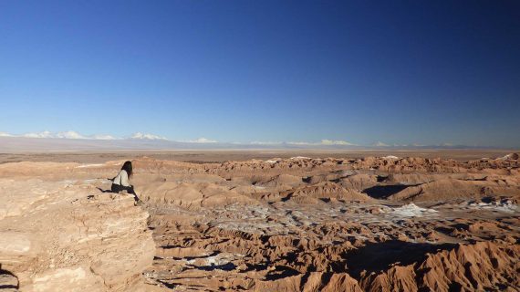 Mulher sentada observando o Valle de la Luna