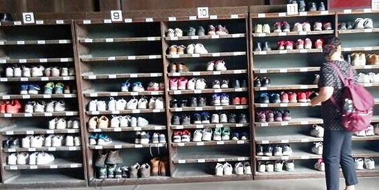 visitors' shoes on racks