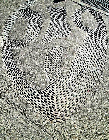 Indian designs made from small pebbles on a pavement at the Malecon