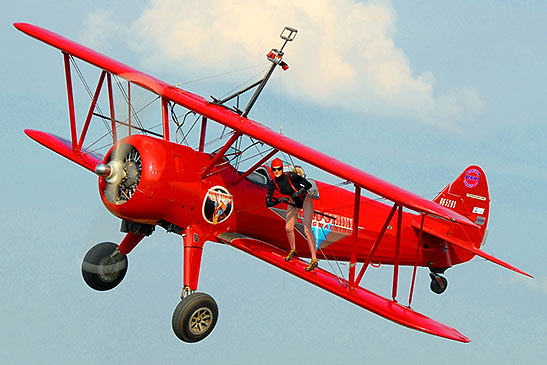stunt-woman wing walker on a Stearman biplane