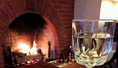 appetizers and fireplace in a Cheshire Cat Inn room