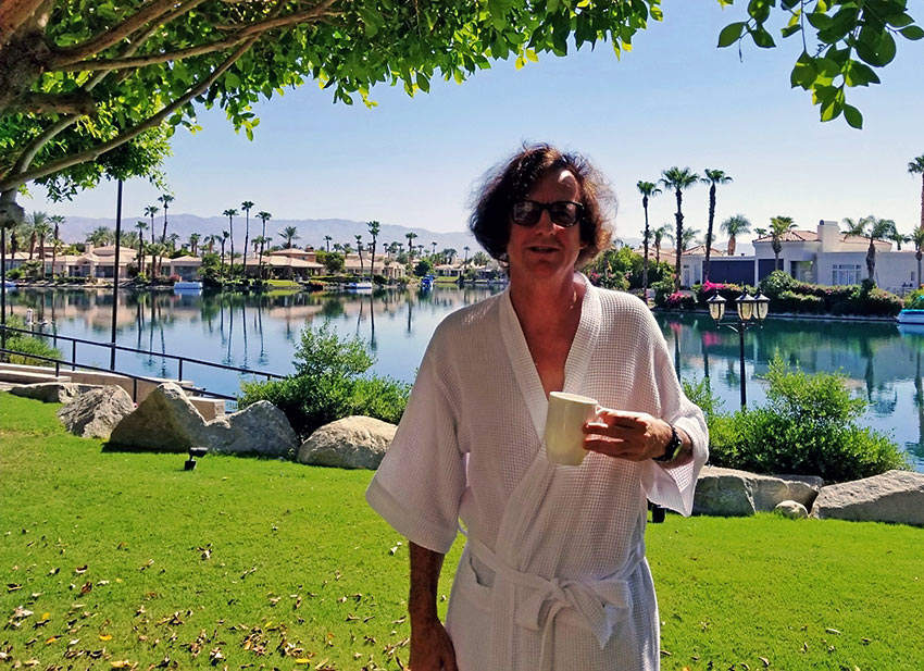 the writer enjoying morning coffee by Lake La Quinta