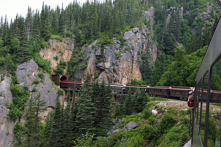 a train emerges from a tunnel on the White Pass and Yukon Route