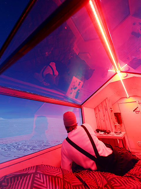 mobile rooms set on skis with a clear Aurora viewing roof