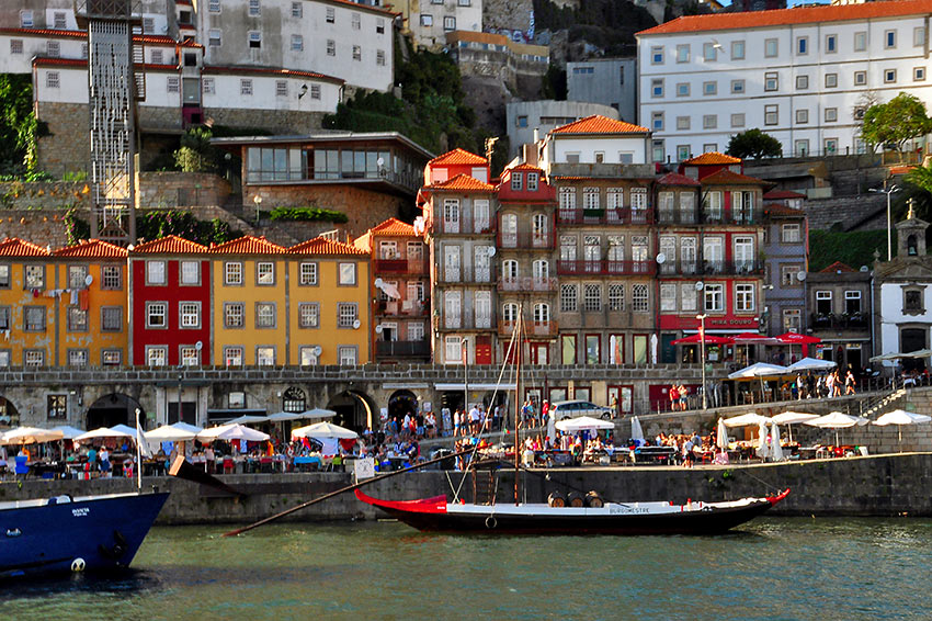 pastel-hue houses, waterfront cafes and bars at the Ribeira neighborhood, Porto