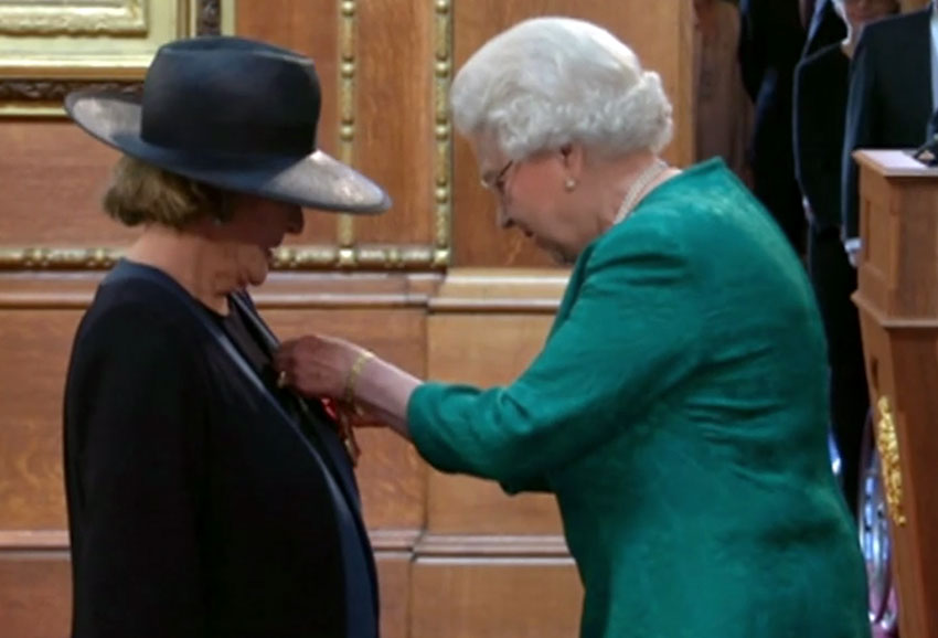Dame Maggie Smith receiving her Damehood honor from Queen Elizabeth II