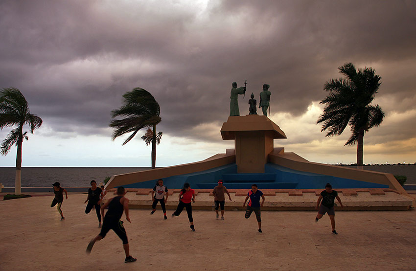locals exercising on Campeche’s malecón with the Gulf of Mexico in the background