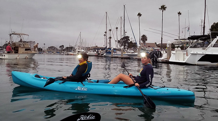 moonlight kayak paddlers at Oceanside Harbor