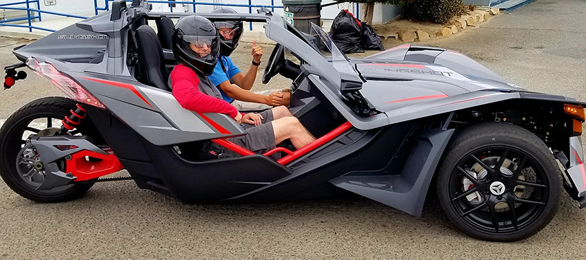 writer on a Polaris Slingshot, Oceanside
