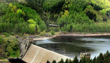 Lancaster Bomber flying low over the Derwent Dam in a recreation of the Moehne Dam Raid of 1943