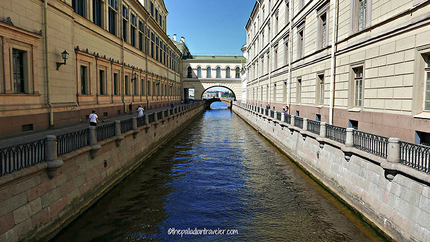 the Moika River passing under a short bridge