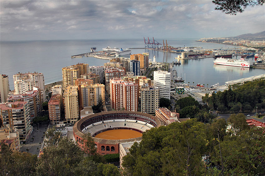 Málaga harbor on the Costa del Sol with the bullring in the foregound