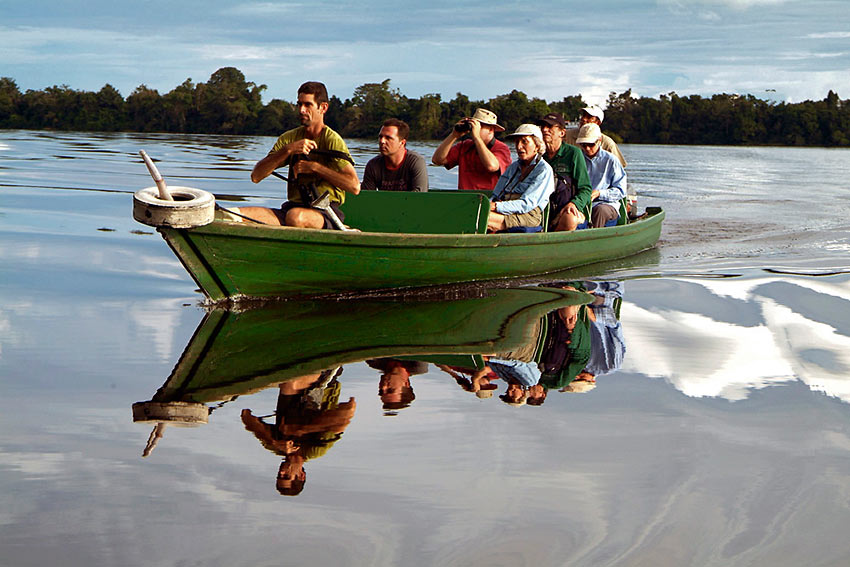 small power launch taking visitors across the River Negro