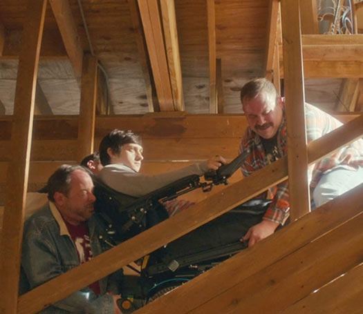 Craig Roberts is carried up one flight of stairs