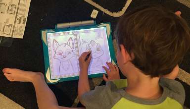 kid with Crayola Light Up Tracing Pad