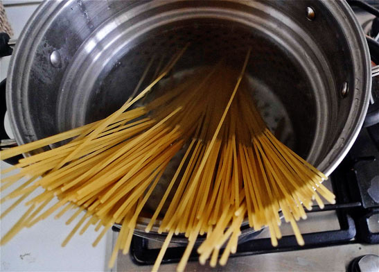spaghetti in a pot of boiling water